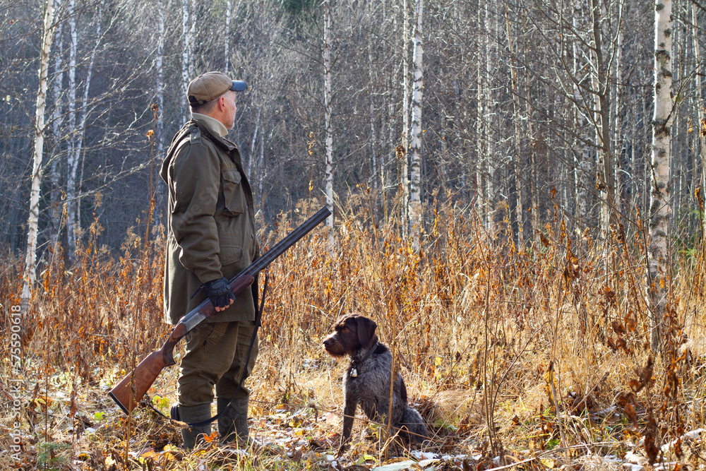 a hunter and his hunting dog on a sunny autumn day
