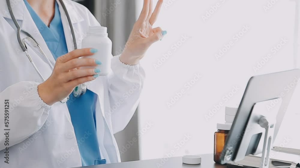 Doctor working with laptop computer and writing on paperwork. Hospital background. Doctor working with laptop computer and writing on paperwork. Hospital background.