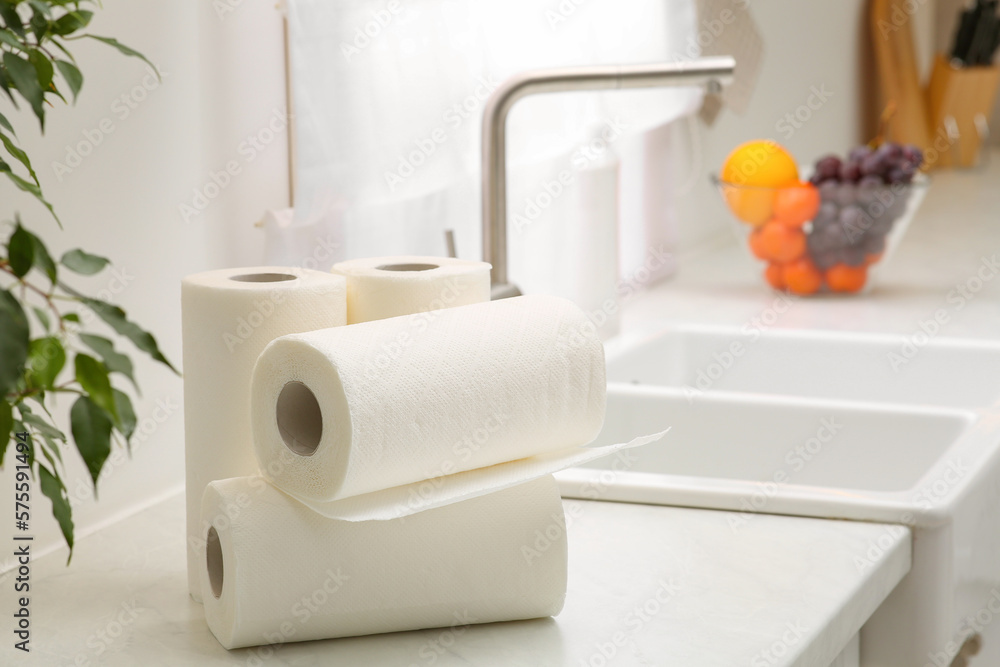 Rolls of paper towels on white countertop in kitchen. Space for text Rolls of paper towels on white countertop in kitchen. Space for text