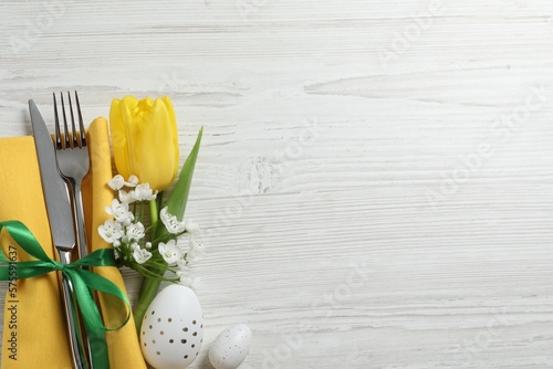 Canvas Print Cutlery set, Easter eggs and beautiful flowers on white wooden table, flat lay