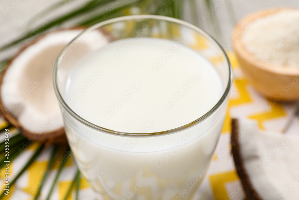 Glass of delicious coconut milk on table, closeup Glass of delicious coconut milk on table, closeup
