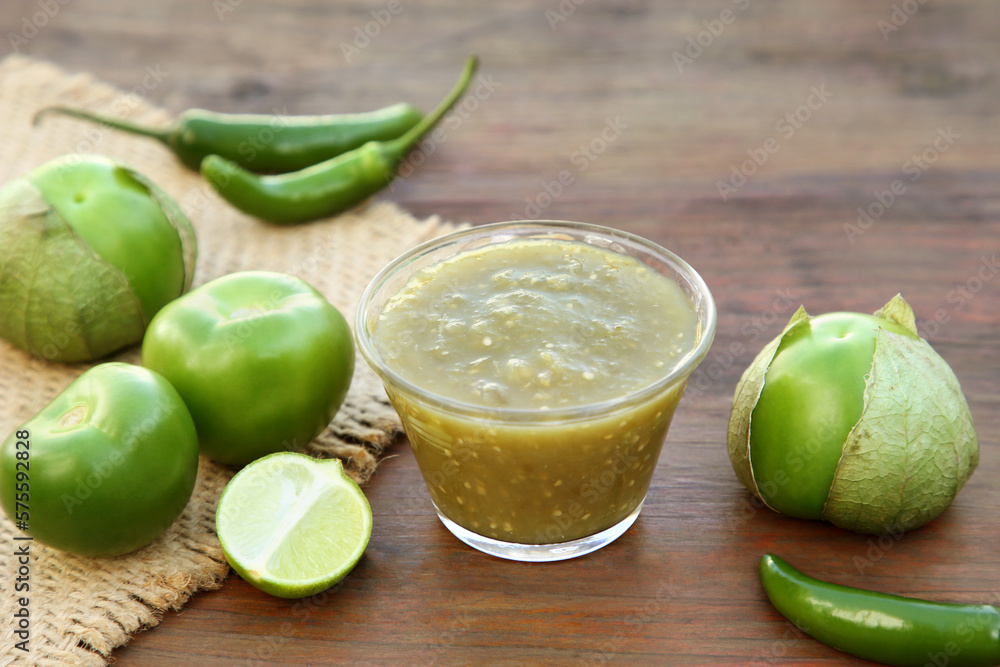 Tasty salsa sauce and ingredients on wooden table, closeup Tasty salsa sauce and ingredients on wooden table, closeup