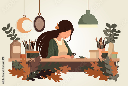 Young woman sitting at the table make organic products, craft concept, artist working