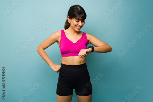 Smiling woman using a smartwatch during exercise