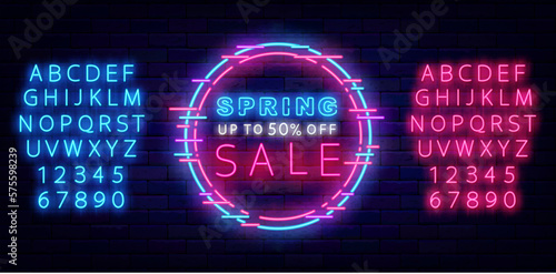 Spring sale neon sign on brick wall. Season special offer. Laser turquoise and pink alphabet. Vector illustration