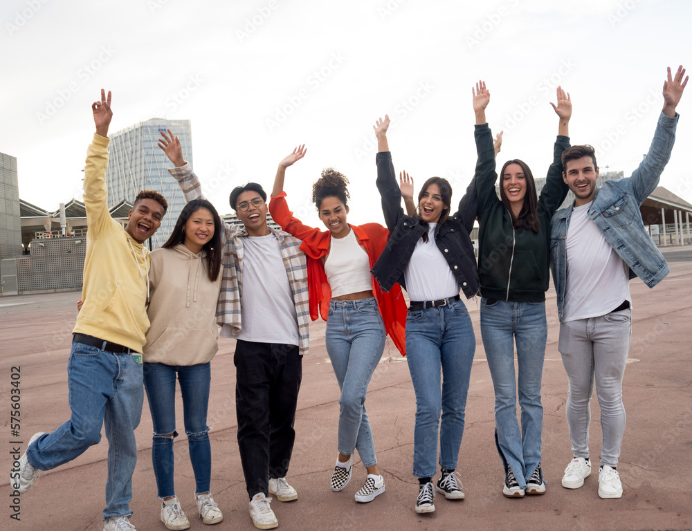 Group of multi-ethnic teenagers laughing and having a good time in a city