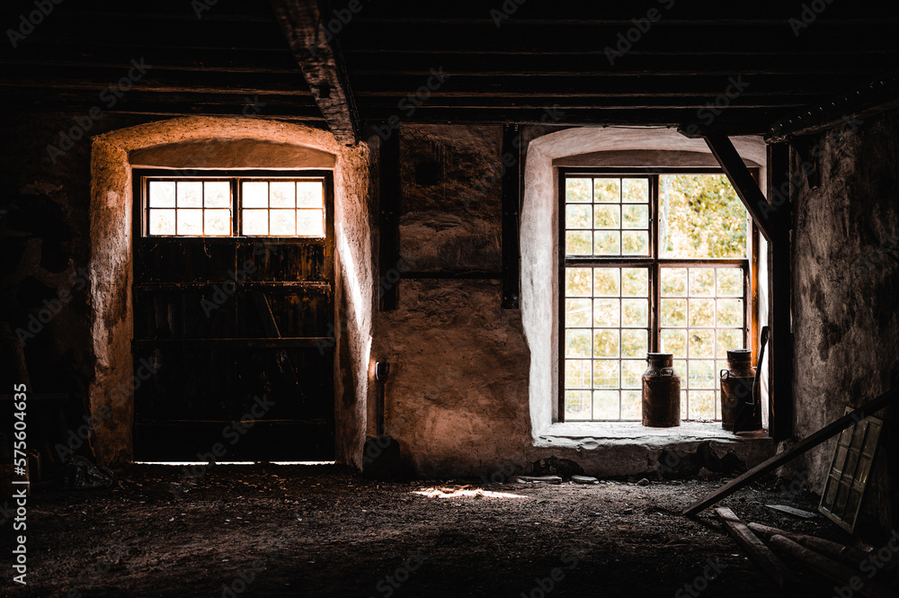 Two old milk churns in a window Two old milk churns in a window