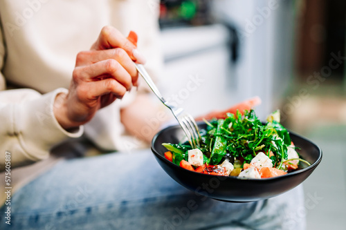 Woman's hands eat wegetables salad photo