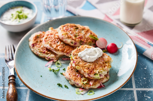 Tasty fritters with onion on plate
