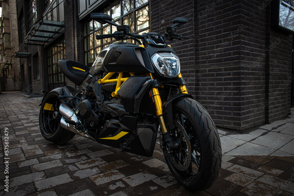stylish black and yellow sports motorcycle on the city street