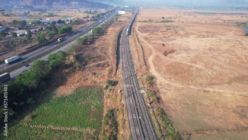 Drone footage of a freight train traveling slowly in the countryside alongside the Mumbai Pune Expressway at Kamshet, near Pune India. photo