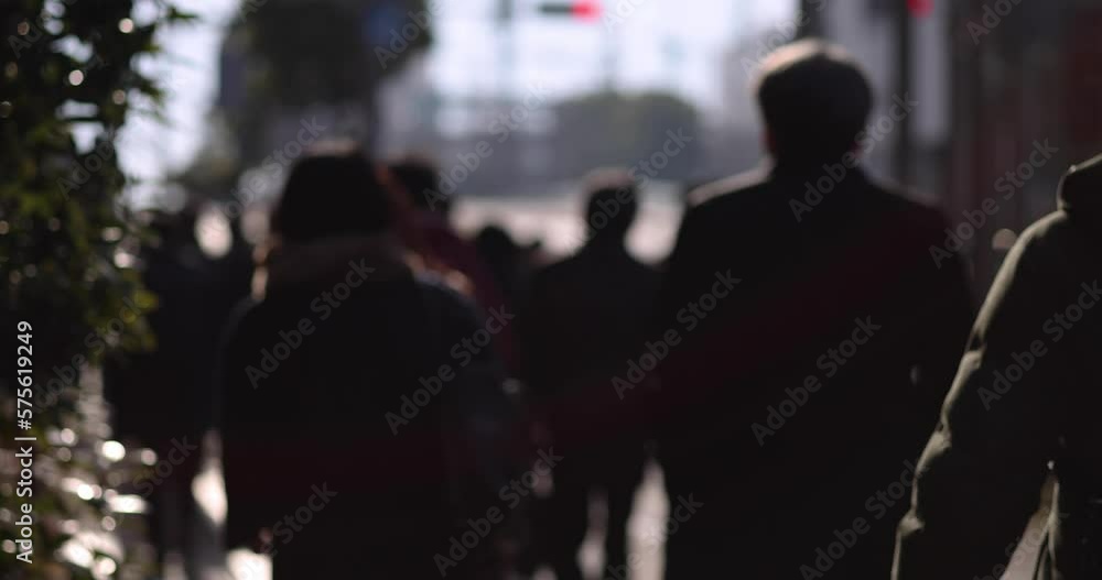 A slow motion of walking people on the city street defocused A slow motion of walking people on the city street defocused