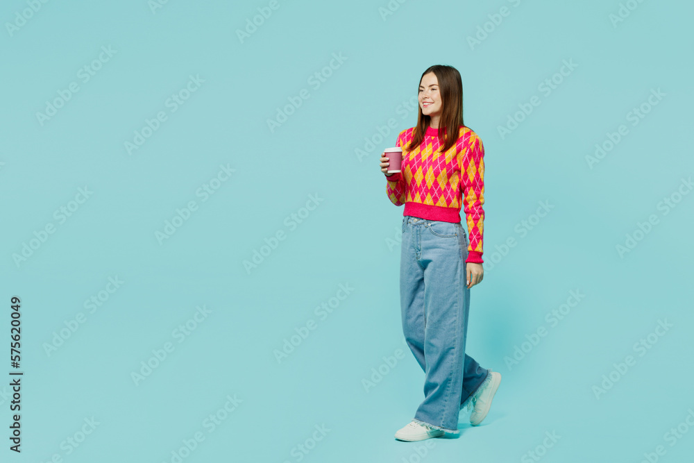 Full body young fun woman wear bright casual clothes hold takeaway delivery craft paper brown cup coffee to go isolated on plain pastel light blue cyan background studio portrait. Lifestyle concept. Full body young fun woman wear bright casual clothes hold takeaway delivery craft paper brown cup coffee to go isolated on plain pastel light blue cyan background studio portrait. Lifestyle concept.