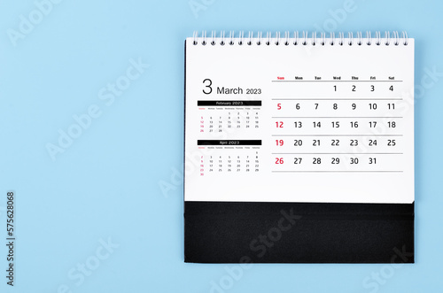 A March 2023 Monthly desk calendar for 2023 year on blue colour background.