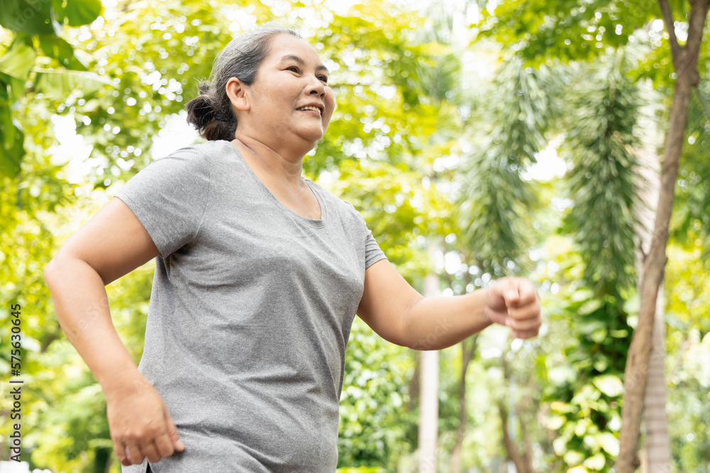 Old senior woman running, jogging, exercising in green park, breathing clean air, good and healthy life quality and wellness concept image Old senior woman running, jogging, exercising in green park, breathing clean air, good and healthy life quality and wellness concept image
