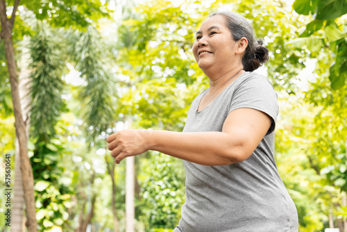 Old senior woman running, jogging, exercising in green park, breathing clean air, good and healthy life quality and wellness concept image © 9nong