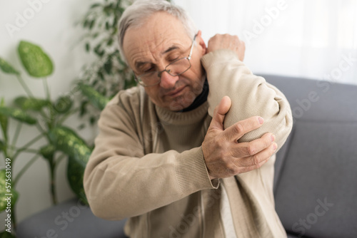 an elderly man hurts his elbow photo