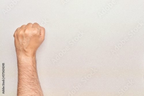 fist up of man with arm on bright white background fighting human rights