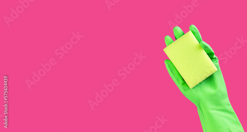 Sponge in hand in green glove on pink ad background, promotion banner design for professional cleaning service