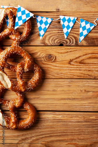 Oktoberfest concept with pretzel and blue simbol flag on wood background