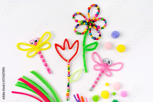 Beaded Pipe Cleaner flowers and dragonflies. Easy spring kids crafts. Different multi-colored supplies and materials for DIY art activity for kids. Children's crafts, creativity and  hobby. © igishevamaria