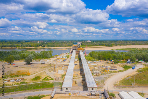 Aerial shot passing over a bridge construction project at sunset in Vistula near Warsaw.  Construction of the Most Polnocny bridge. Poland photo