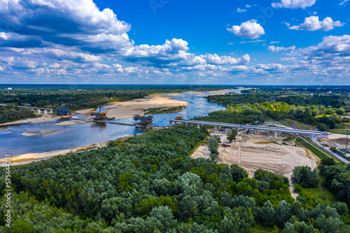 Aerial shot passing over a bridge construction project at sunset in Vistula near Warsaw.  Construction of the Most Polnocny bridge. Poland © netsay