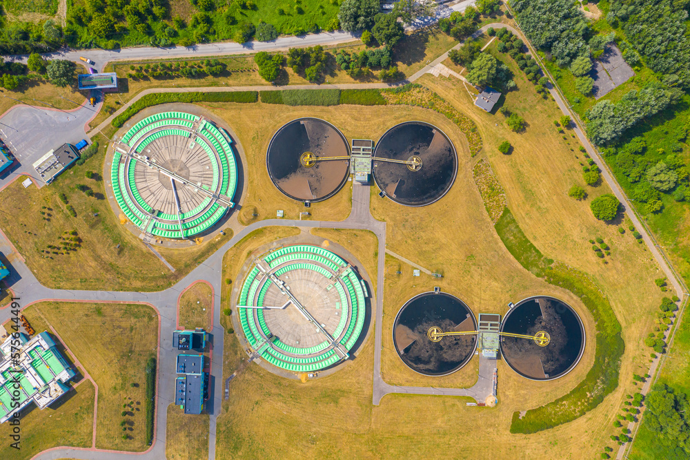 Aerial view of modern water cleaning facility at urban wastewater treatment plant. Purification process of removing undesirable chemicals, suspended solids and gases from contaminated liquid Aerial view of modern water cleaning facility at urban wastewater treatment plant. Purification process of removing undesirable chemicals, suspended solids and gases from contaminated liquid