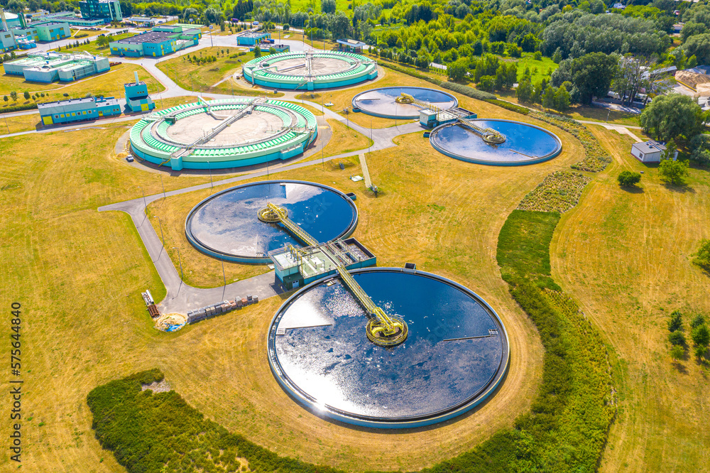 Aerial view of modern water cleaning facility at urban wastewater treatment plant. Purification process of removing undesirable chemicals, suspended solids and gases from contaminated liquid Aerial view of modern water cleaning facility at urban wastewater treatment plant. Purification process of removing undesirable chemicals, suspended solids and gases from contaminated liquid