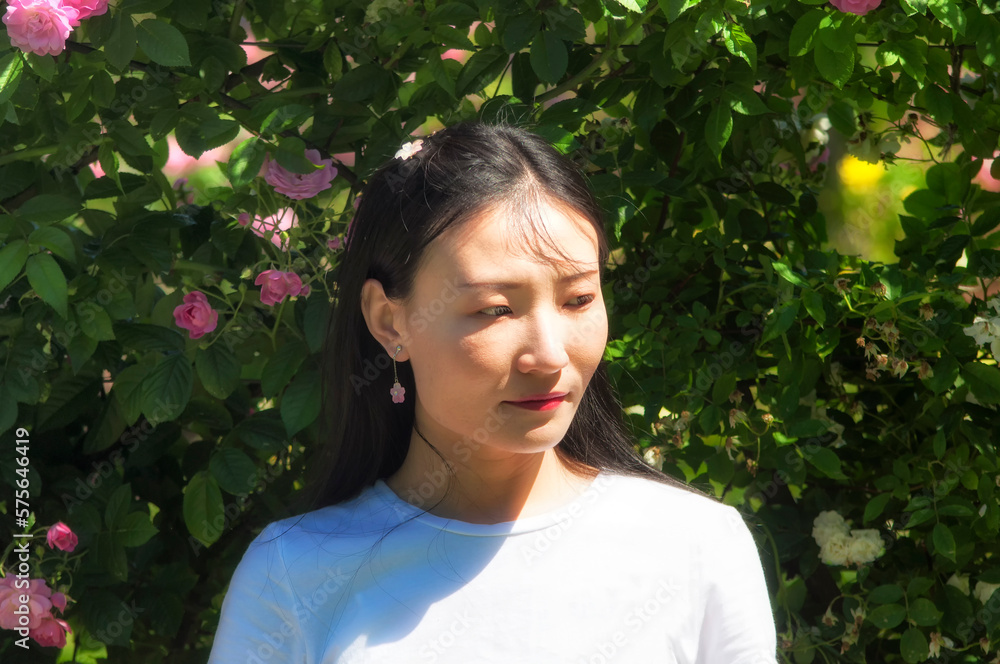 sad chinese woman in a rose garden sad chinese woman in a rose garden