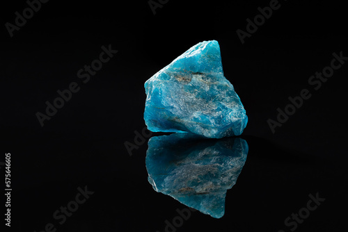 Raw Blue Apatite Uncut Gem Stone on Black Surface photo