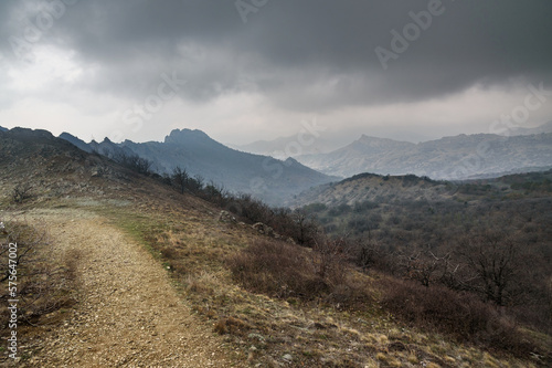 Landscape of Karadag Reserve in spring. View of mountains in fog and clouds. Crimea