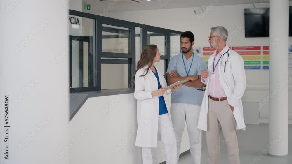 Doctors discussing something at hospital corridor. Doctors discussing something at hospital corridor.