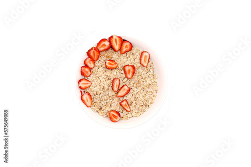 Oatmeal porridge with summer strawberries berries. Porridge oats in bowl. Healthy food breakfast,lifestyle,dieting, proper nutrition. Top view flat lay on gray table background, copy space