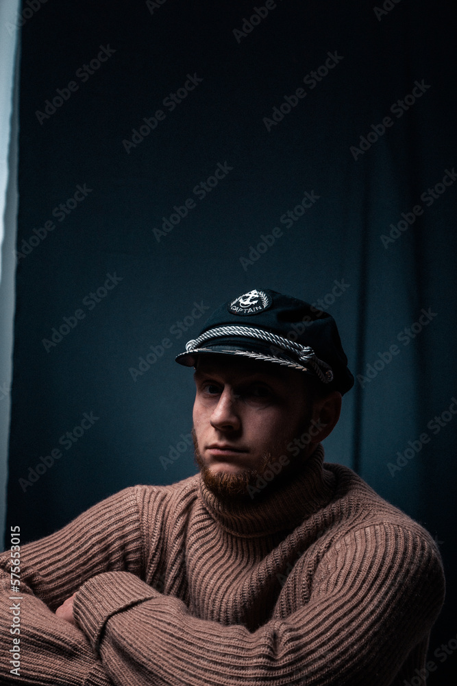 Vessel captain. A man in a sweater and cap. Smokes a pipe. Male profession. Vessel captain. A man in a sweater and cap. Smokes a pipe. Male profession.