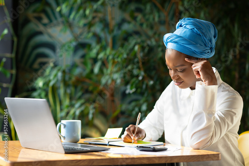 Wallpaper Mural Young black woman looking for job online, sitting at cafe Torontodigital.ca