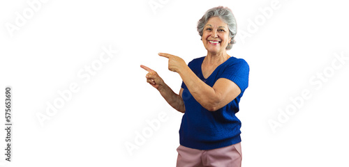 Women's Day - Smiling Mature Woman Pointing Isolated on Orange Background