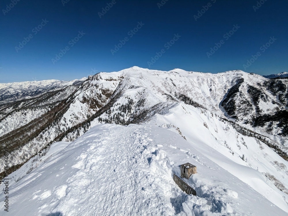 White trail leading to Mt. Hotaka seen from Mt. Kengamine in Kawaba Village, Gunma Prefecture, Japan in February.