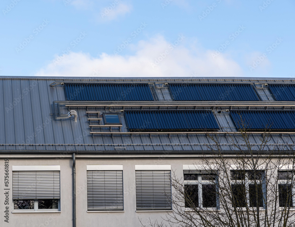 solar thermal system on a roof of a building, blue sky 