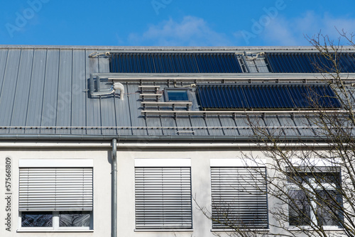 Konstfotografi solar thermal system on a roof of a building, blue sky