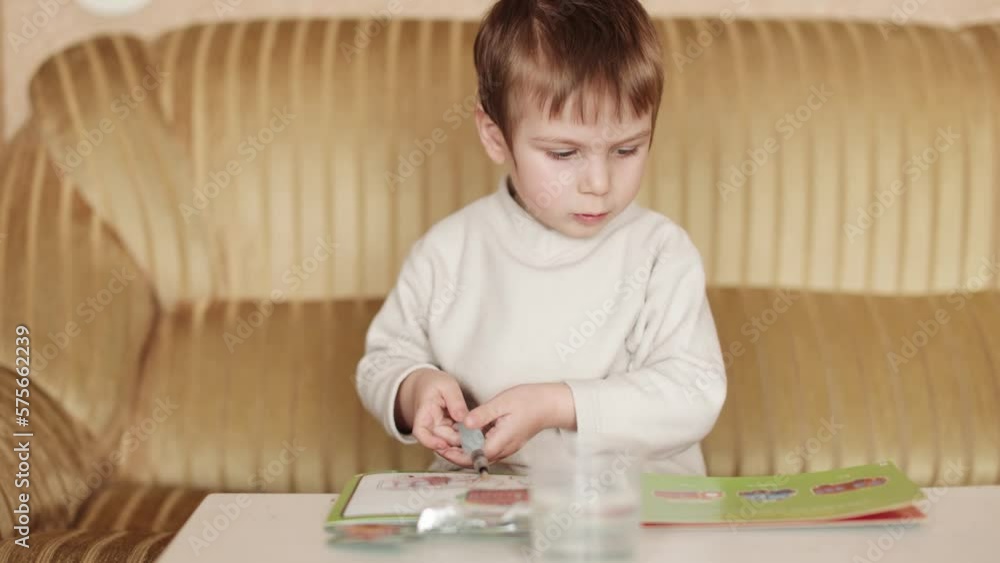 Child boy draws with a water marker Child boy draws with a water marker