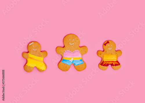 Gingerbread men on a pink background. Mother and baby girls. Happy women s day. Mother s Day - place for text.