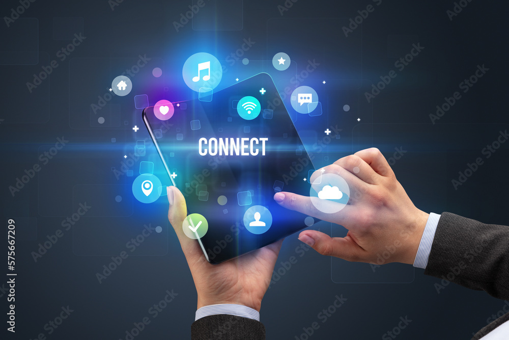 Businessman holding a foldable smartphone Businessman holding a foldable smartphone