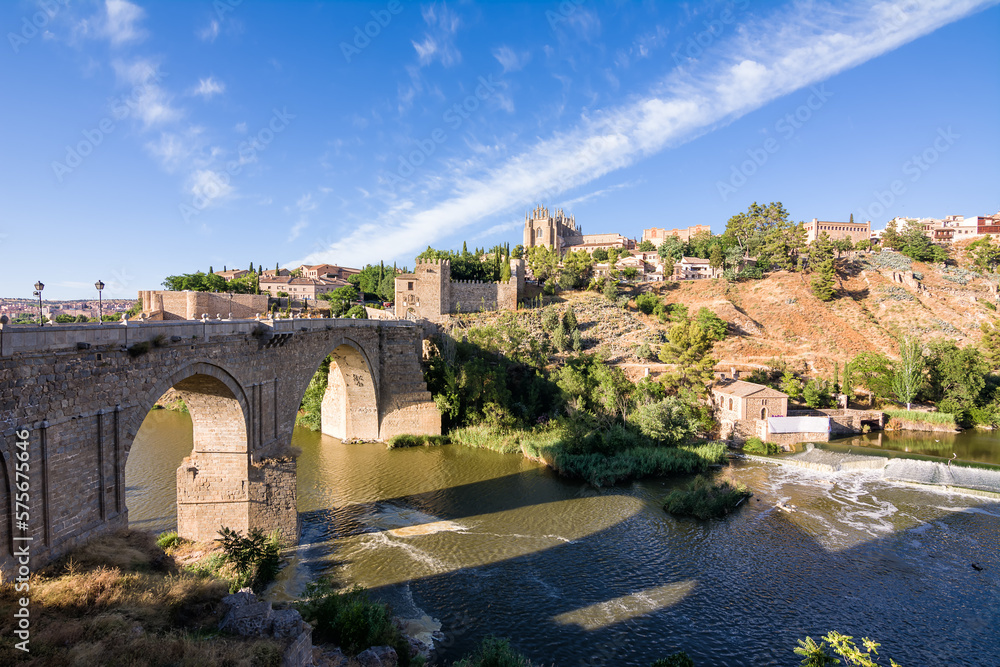 View of the San Martin Bridge crossing the Tagus to enter the old city of Toledo on the hill where you see the Old Cathedral