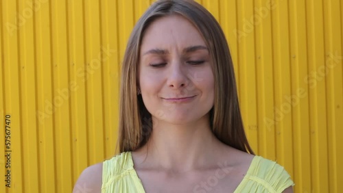 Young woman playing funny face a squinting eyes, strabismus squint happy woman having fun smiling twisting her eyes lifestyle funny content