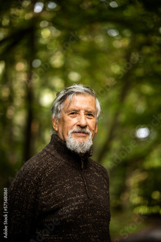Elderly caucasian male walking outdoors on an autumn, fall day