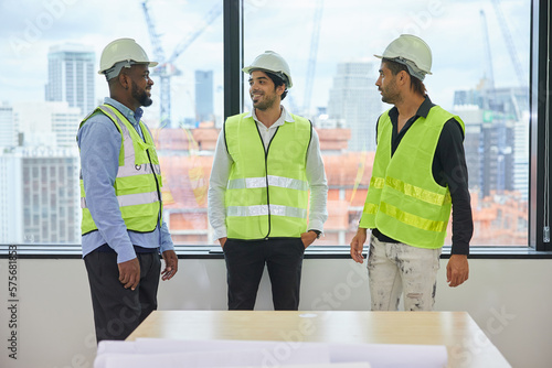 group of engineers meeting and talking about work or projects on construction site