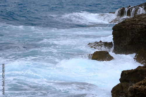 waves breaking on a Tuscan cliff