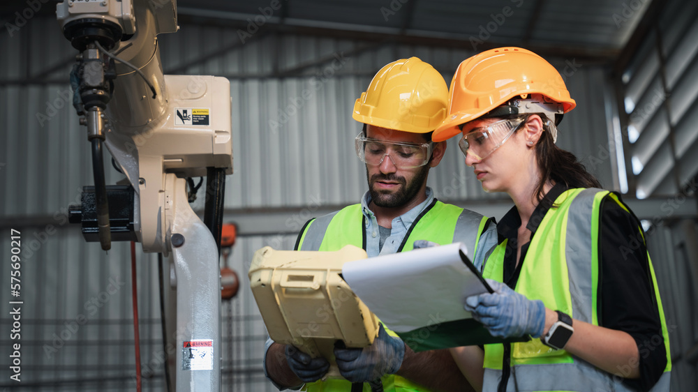 Industrial engineers are in charge of controlling the automated robot arms machine welding robots in industrial manufacturing factory. Industrial engineers are in charge of controlling the automated robot arms machine welding robots in industrial manufacturing factory.