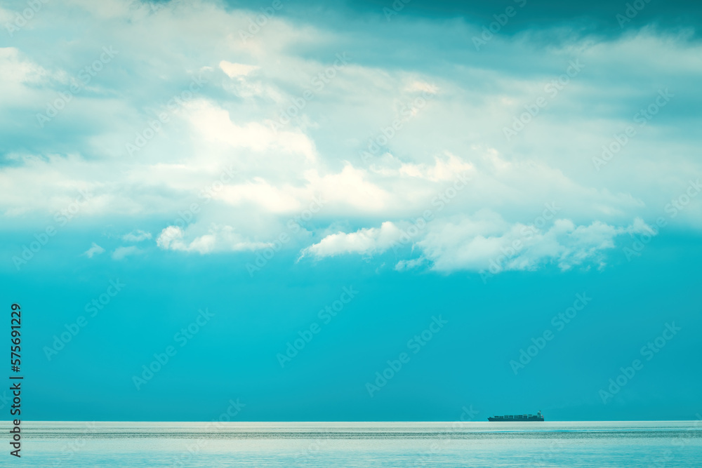 Large container ship sailing at sea in overcast morning Large container ship sailing at sea in overcast morning